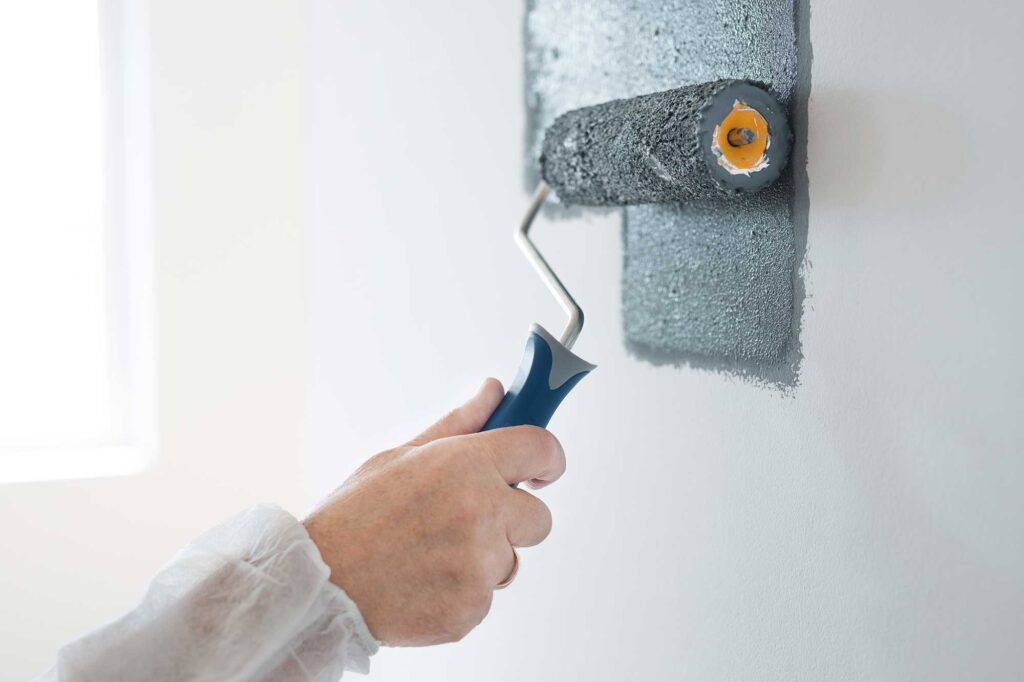 closeup-of-renovation-crew-painting-wall-grey-with-2024-10-18-09-00-04-utc