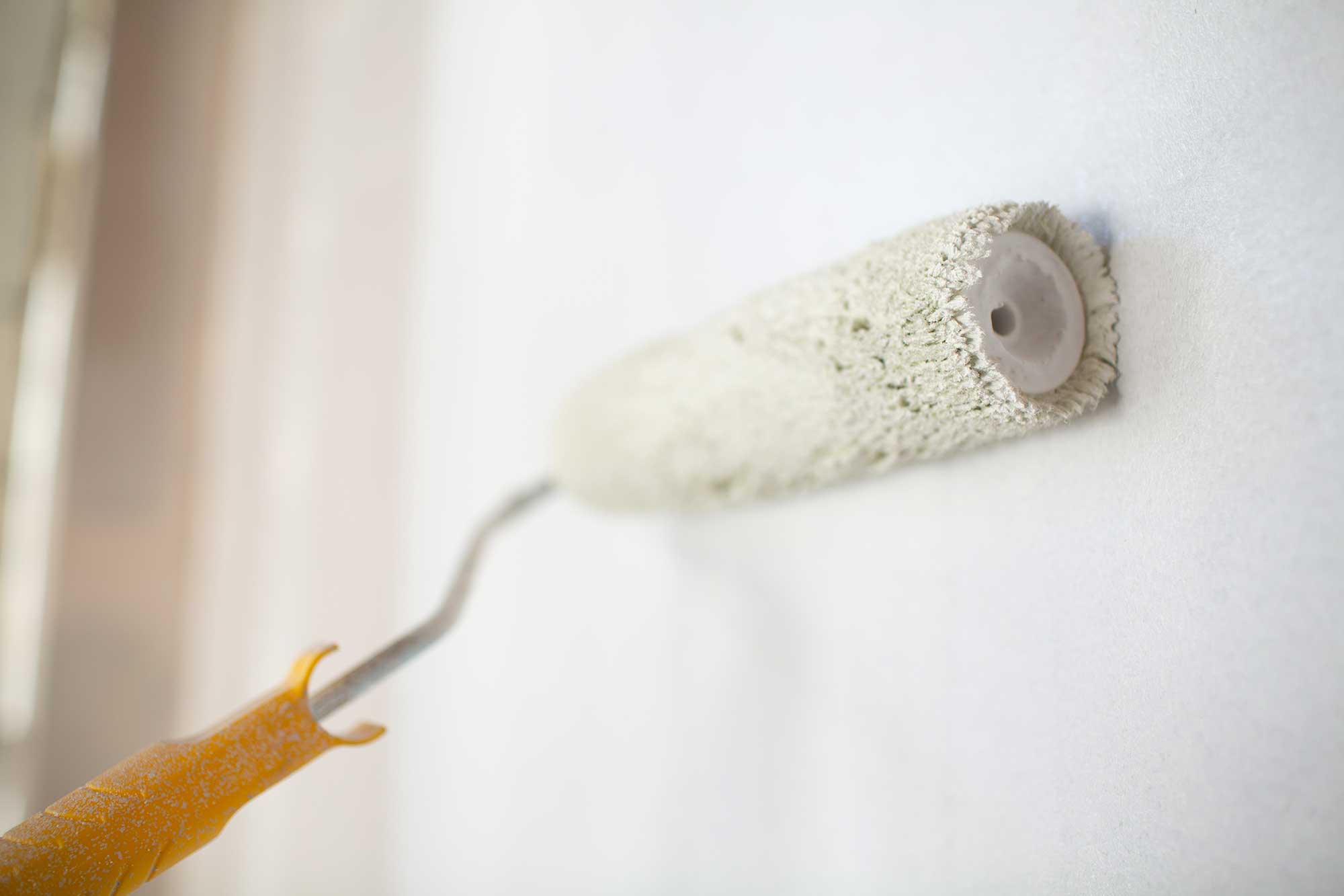 white-paint-roller-in-hand