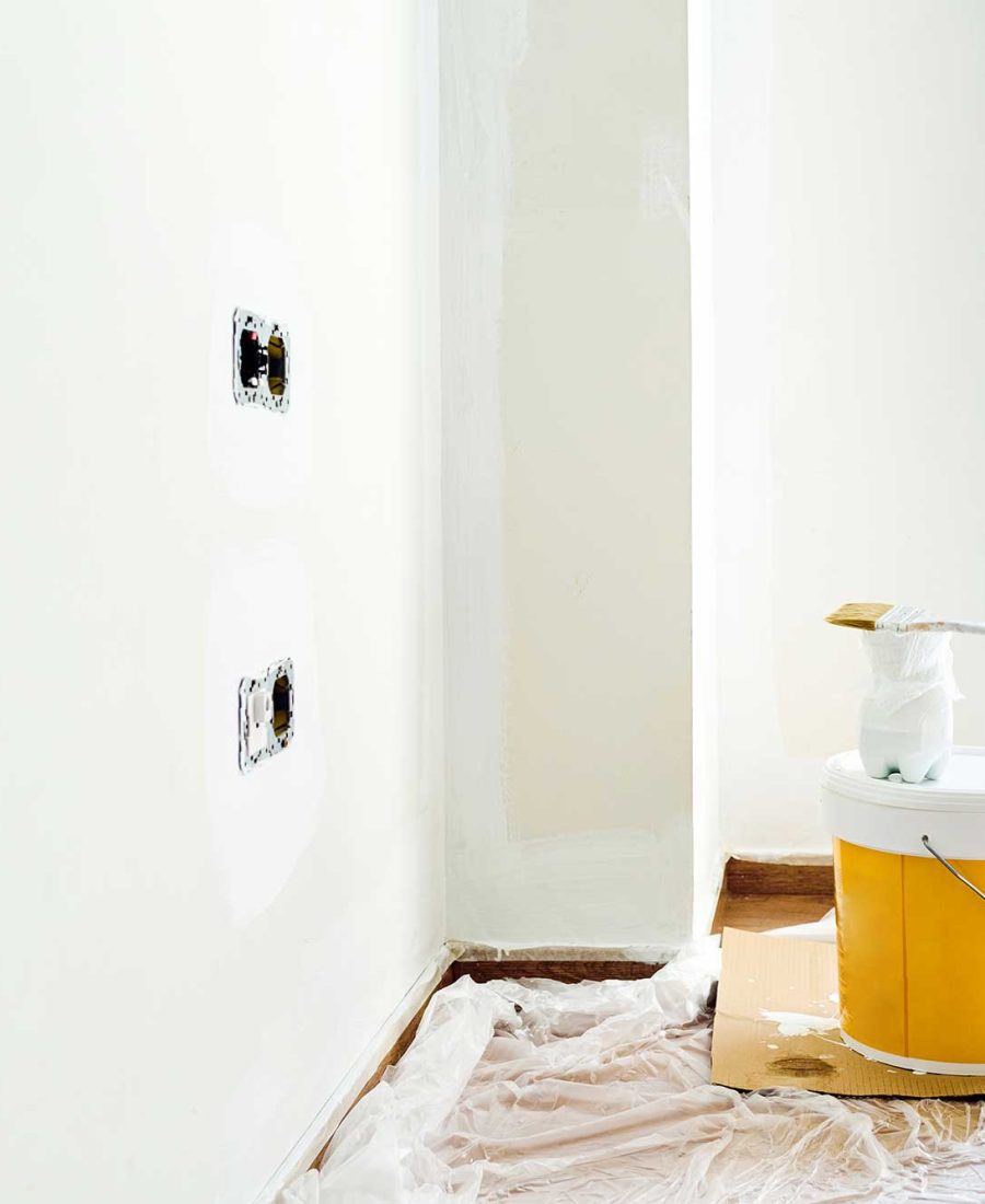 bucket-of-white-paint-with-a-brush-in-a-room-under-2024-10-18-09-34-18-utc